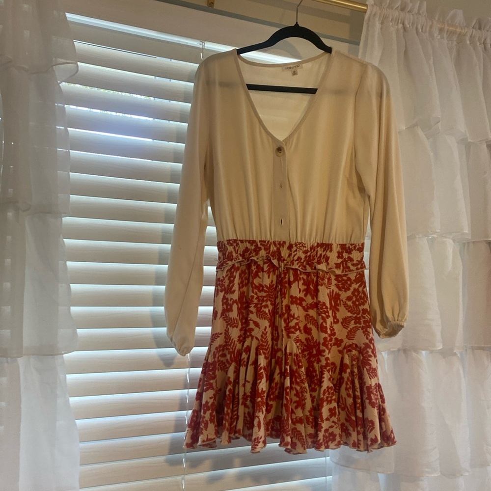 A Romper that looks like a dress, tan with red floral pattern and tan buttons